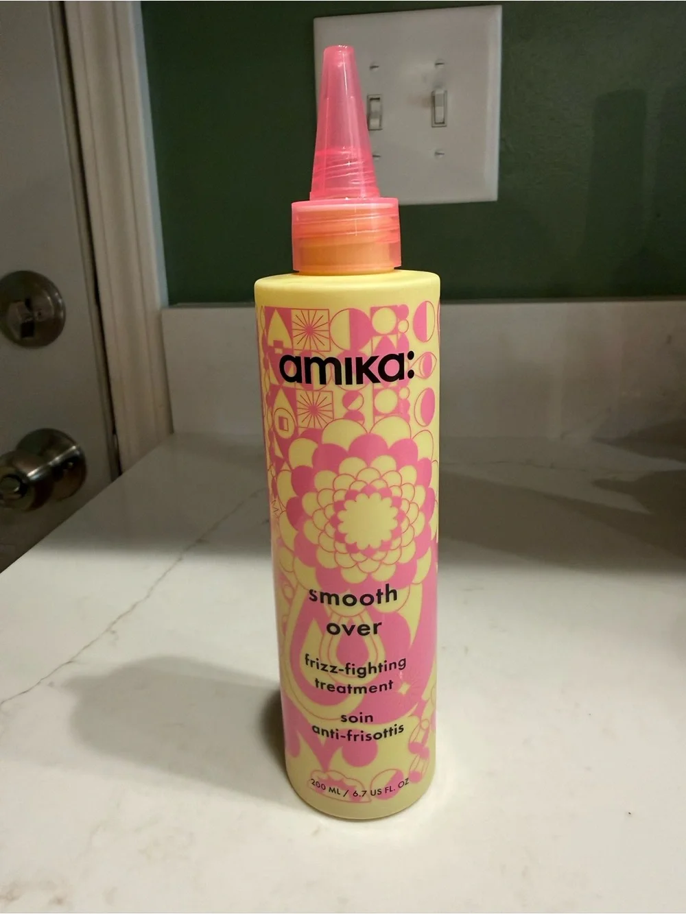 amika Smooth Over Frizz-Fighting Treatment — Yellow & Pink Bottle